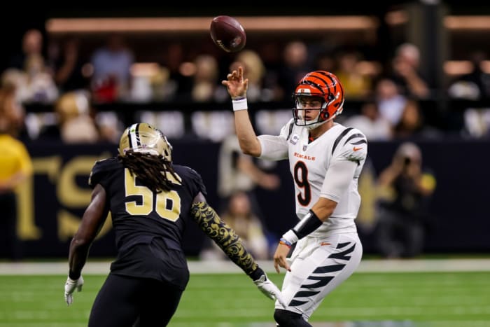 Cincinnati Bengals quarterback Joe Burrow (9) throws the ball away before being sacked by New Orleans Saints linebacker Demario Davis (56). Mandatory Credit: Stephen Lew-USA TODAY Sports